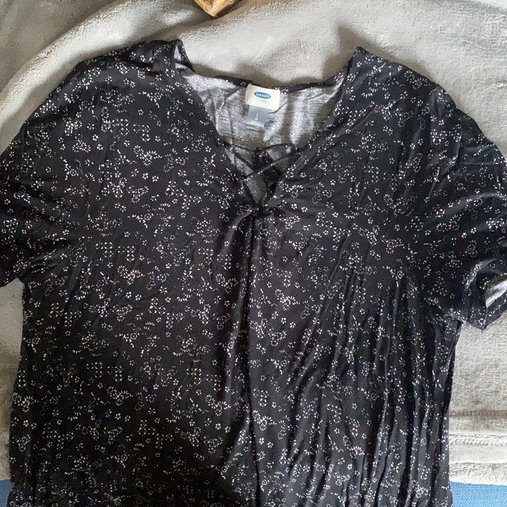Black shirt with flowers crossed in the front.